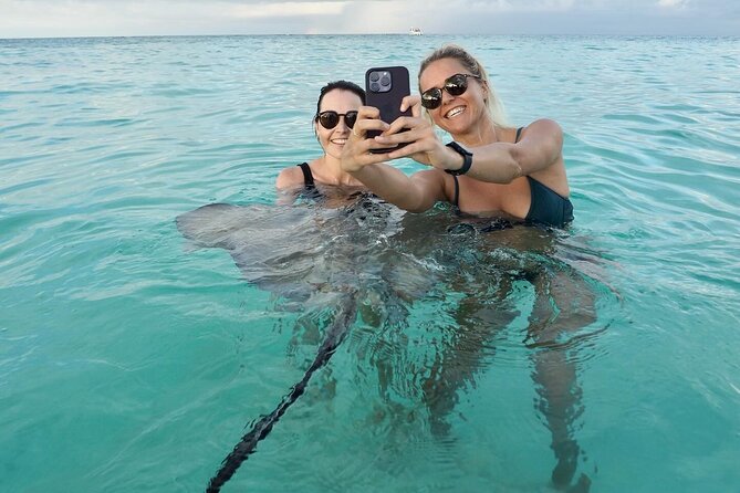 Grand Cayman Catamaran Tour to Stingray City and Rum Point - Stingray City sandbar: shallow water fun with a guide’s help